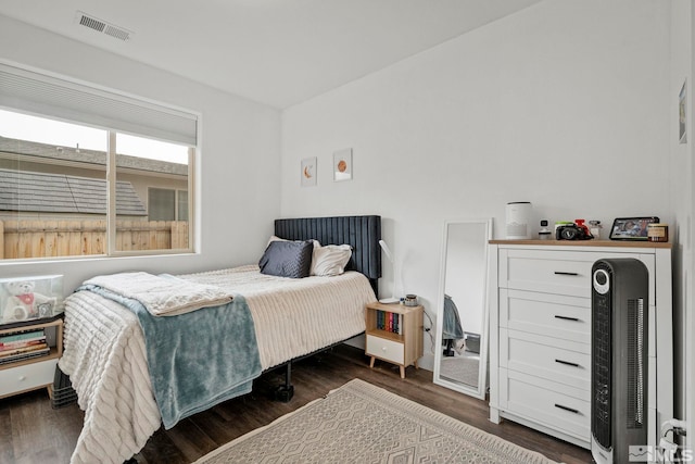 bedroom with dark wood-type flooring