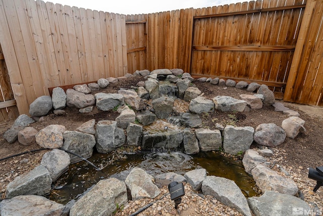 view of yard with a small pond