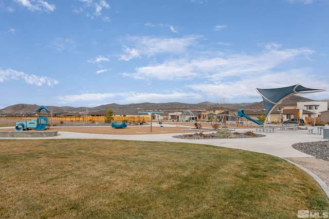 view of jungle gym featuring a yard and a mountain view