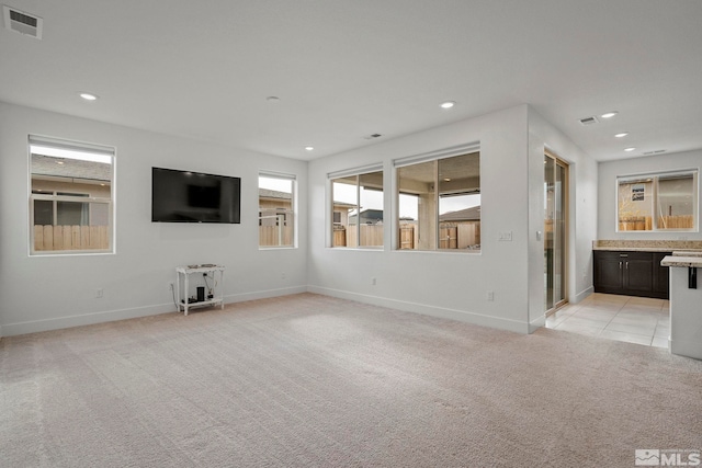 unfurnished living room with light carpet