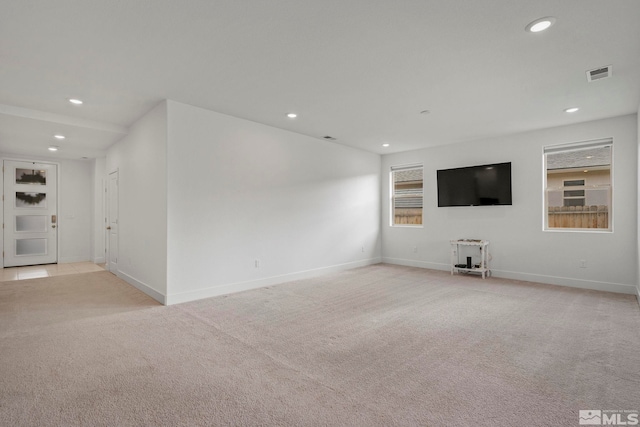 unfurnished living room with light colored carpet