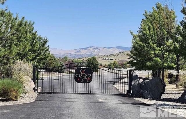 view of gate with a mountain view