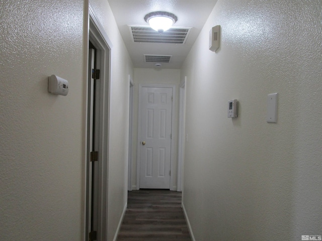 hallway with dark wood-type flooring