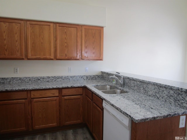 kitchen featuring sink, kitchen peninsula, white dishwasher, light stone countertops, and dark hardwood / wood-style flooring