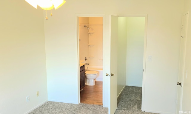 full bathroom featuring shower / washtub combination, vanity, wood-type flooring, and toilet