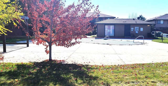 rear view of house featuring a patio area and a fenced in pool