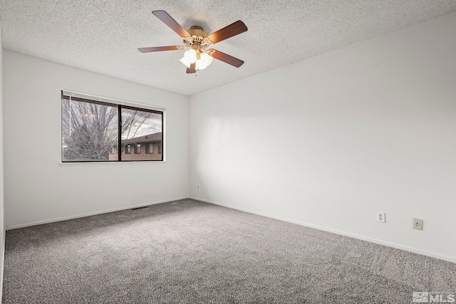 empty room featuring ceiling fan, carpet floors, and a textured ceiling