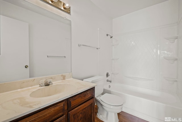 full bathroom with hardwood / wood-style flooring, vanity,  shower combination, and toilet