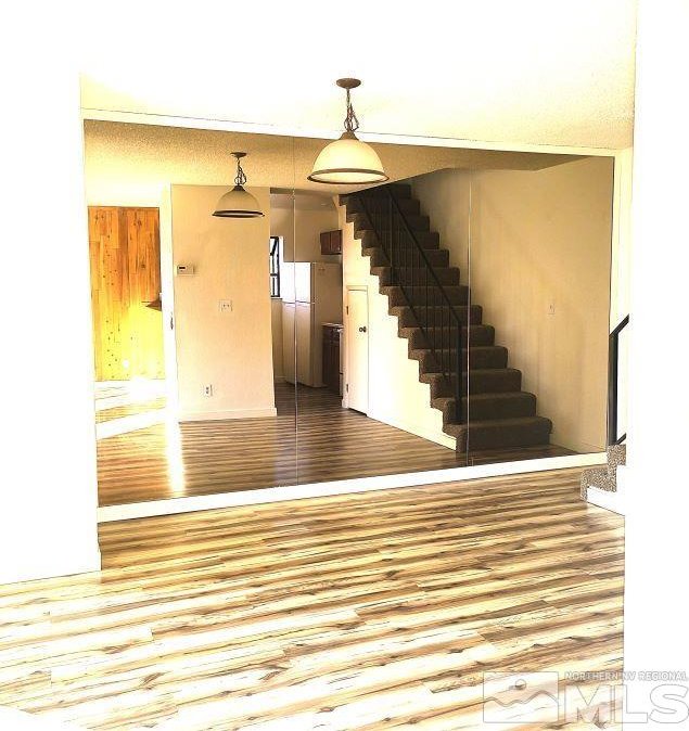 interior space with hardwood / wood-style floors and a textured ceiling