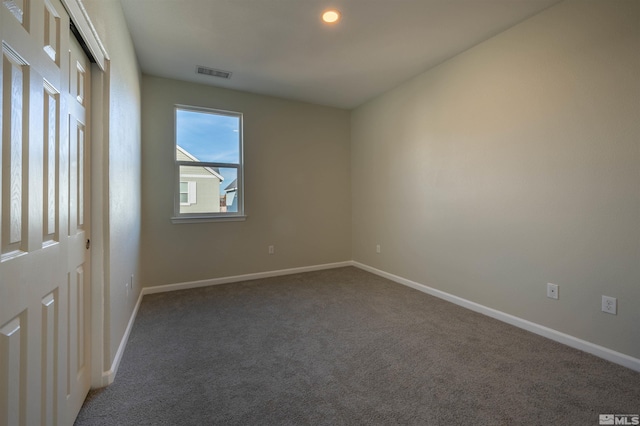 unfurnished bedroom featuring dark colored carpet