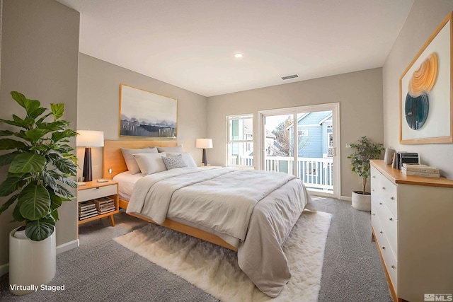 bedroom featuring access to exterior and dark colored carpet