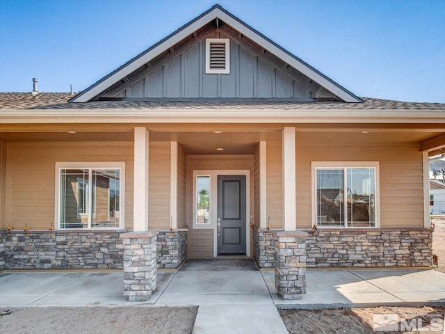 view of exterior entry with a porch