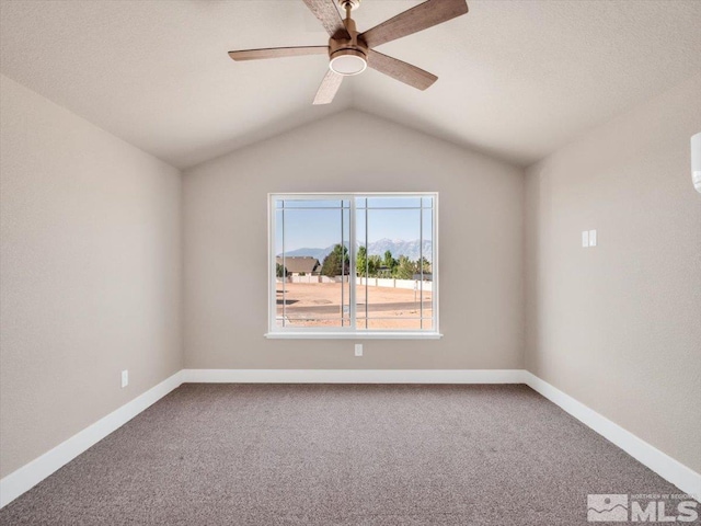 carpeted spare room with ceiling fan and lofted ceiling