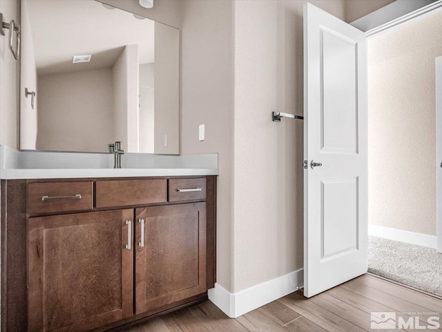 bathroom featuring vanity and wood-type flooring