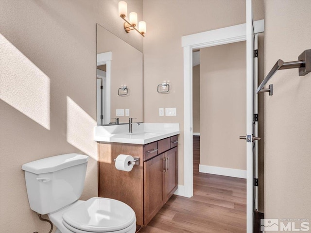 bathroom with vanity, hardwood / wood-style floors, and toilet