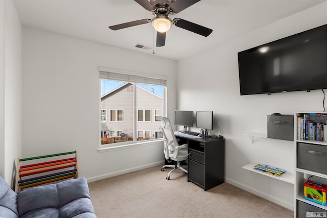 carpeted home office with ceiling fan