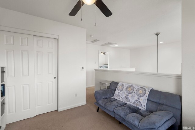 sitting room featuring carpet flooring and ceiling fan