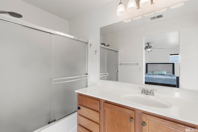 bathroom featuring ceiling fan, vanity, and enclosed tub / shower combo