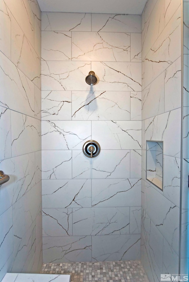 bathroom featuring tiled shower