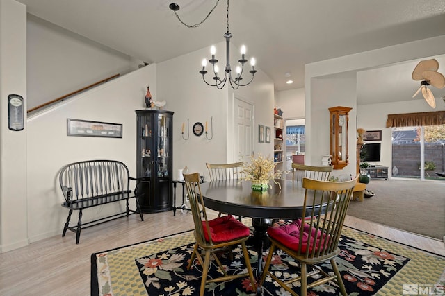 dining space with light wood-type flooring, an inviting chandelier, and a healthy amount of sunlight