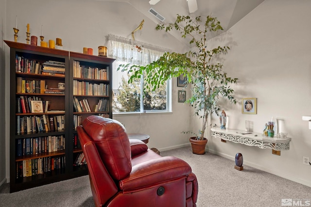 sitting room featuring carpet and vaulted ceiling