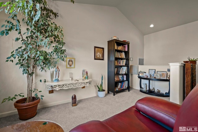 sitting room featuring carpet flooring and lofted ceiling