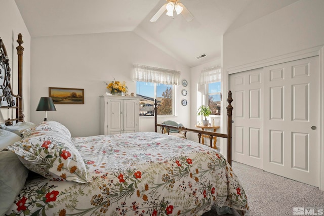 carpeted bedroom featuring a closet, vaulted ceiling, and ceiling fan