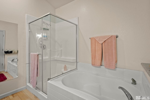 bathroom with separate shower and tub and hardwood / wood-style floors