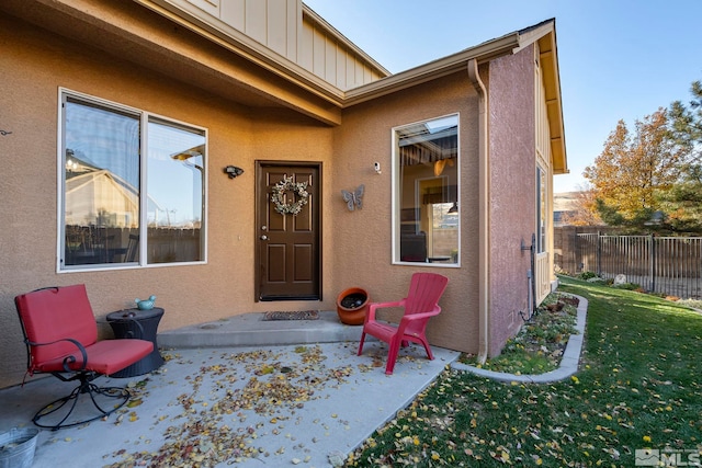 property entrance with a lawn