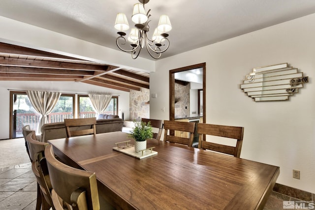 dining room with lofted ceiling with beams and an inviting chandelier