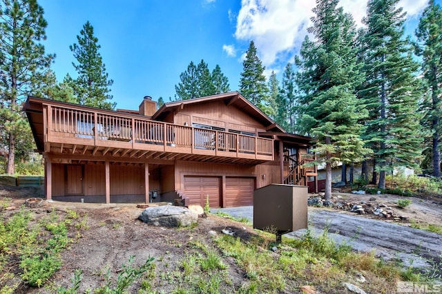 view of front property featuring a garage and a deck