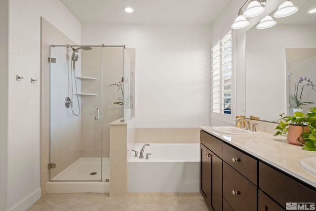 bathroom with tile patterned floors, vanity, and separate shower and tub