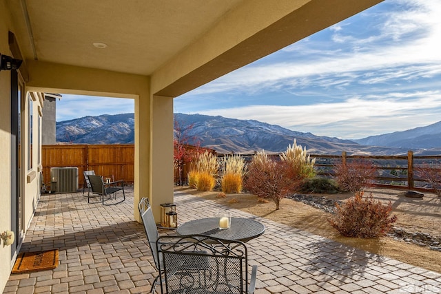 view of patio / terrace with a mountain view and cooling unit