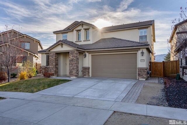 view of front of home with a garage and a front lawn