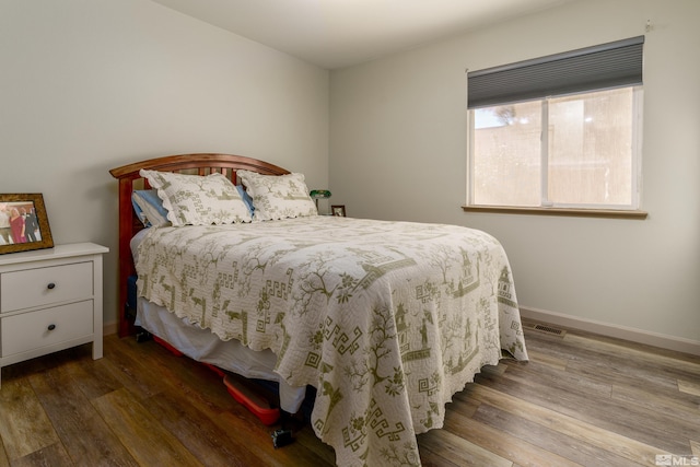 bedroom with hardwood / wood-style floors