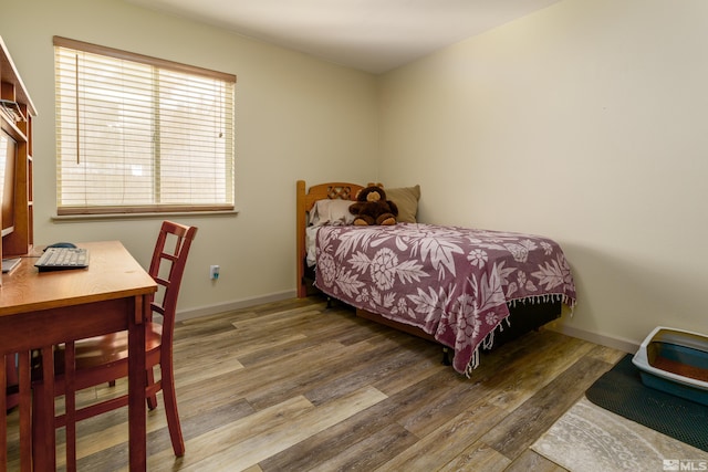 bedroom with hardwood / wood-style floors