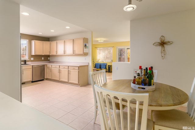 kitchen with light brown cabinetry, dishwasher, and light tile patterned floors