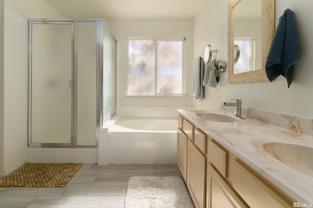 bathroom with vanity and independent shower and bath