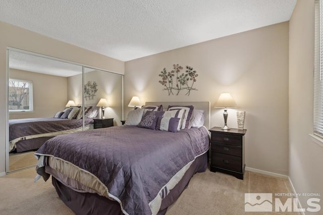 bedroom with light carpet, a closet, and a textured ceiling