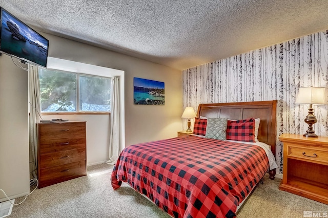 bedroom with a textured ceiling and light carpet