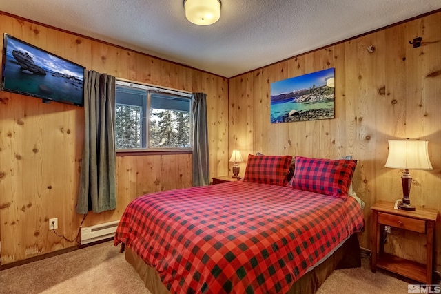 carpeted bedroom featuring wood walls, a textured ceiling, and a baseboard heating unit