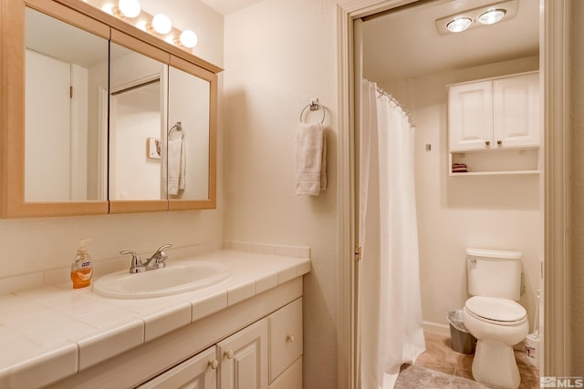 bathroom with tile patterned floors, vanity, and toilet