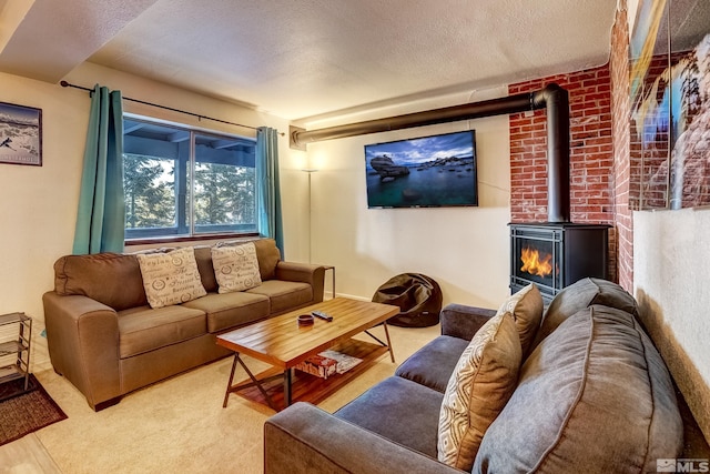 carpeted living room with a wood stove and a textured ceiling