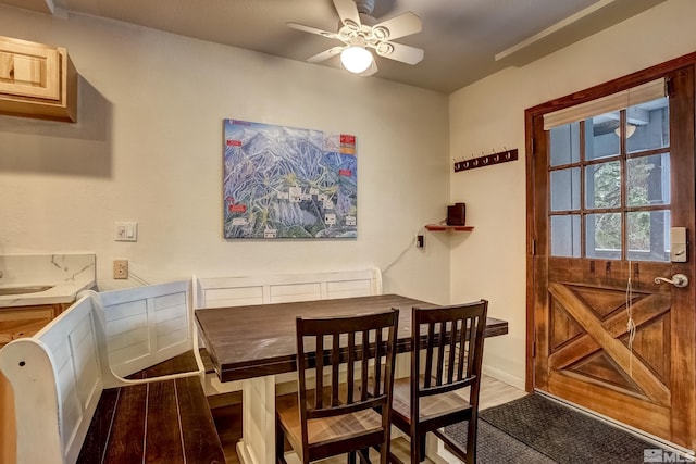 dining space featuring ceiling fan and wood-type flooring