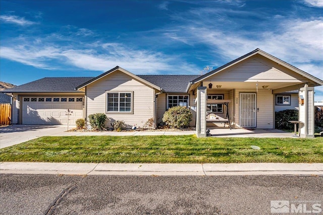 ranch-style house featuring covered porch, a garage, and a front yard