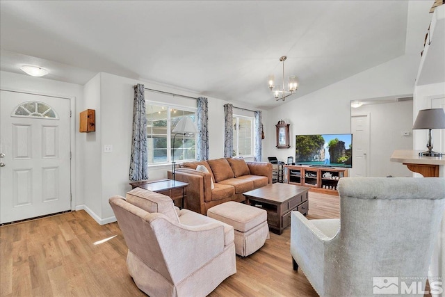 living room featuring light hardwood / wood-style flooring, vaulted ceiling, and an inviting chandelier