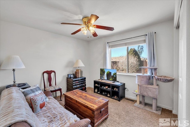 living room featuring ceiling fan and light colored carpet