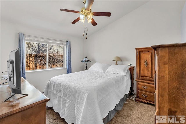 bedroom featuring ceiling fan, light colored carpet, and vaulted ceiling