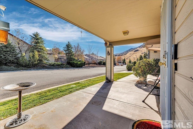 view of patio / terrace featuring a mountain view