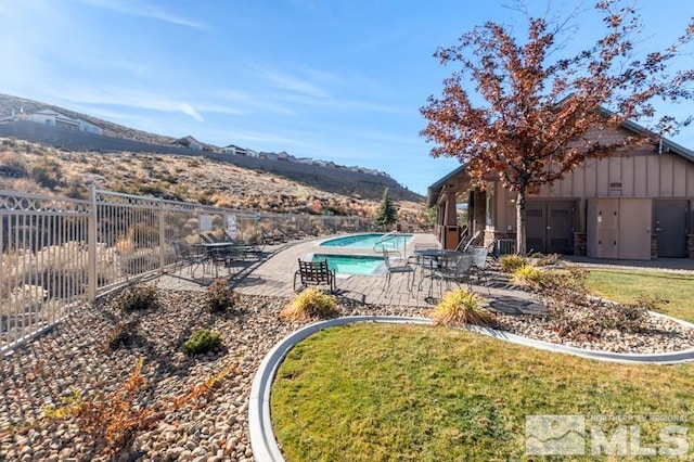 view of yard with a mountain view, a fenced in pool, and a patio